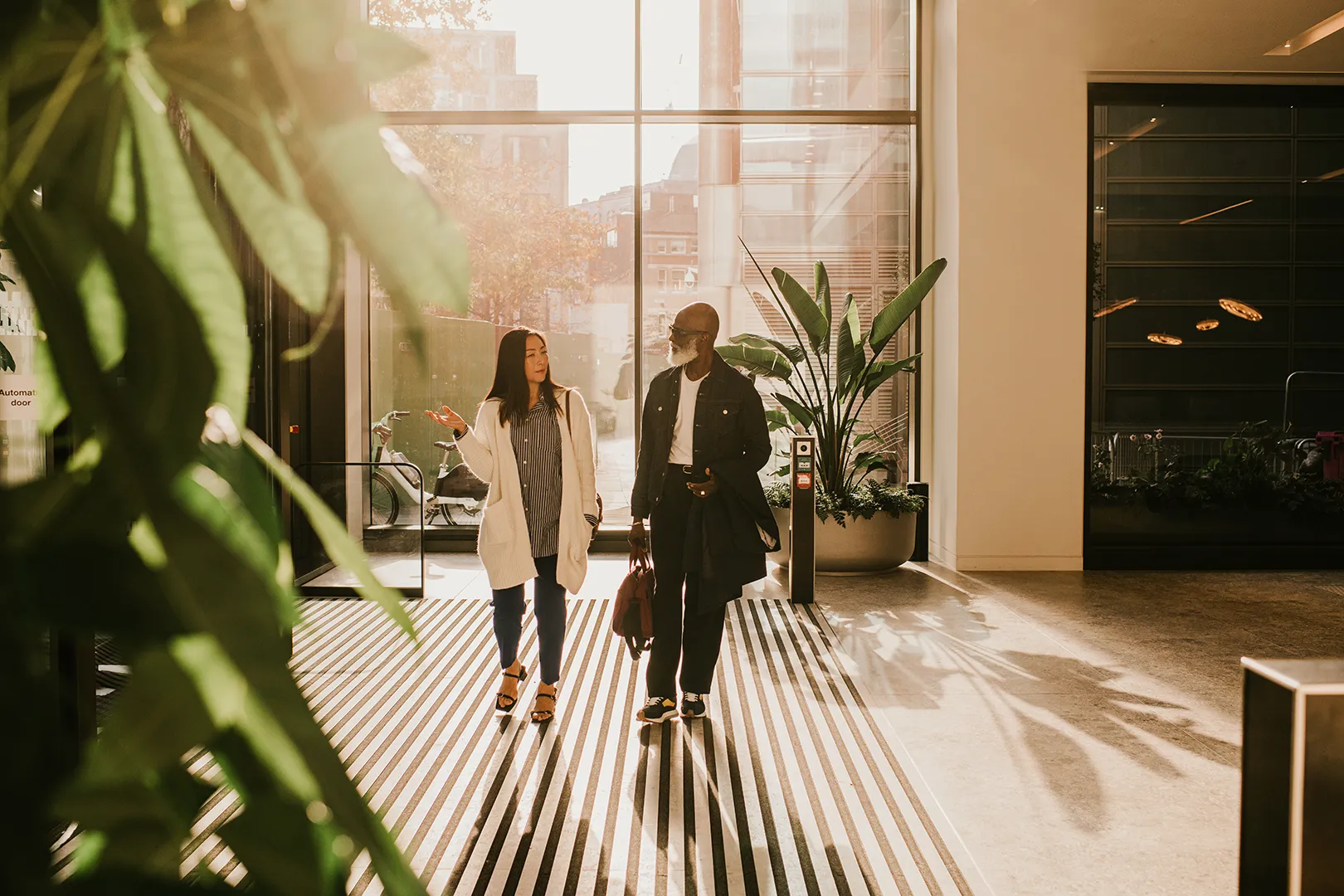 businessman and woman walking into office