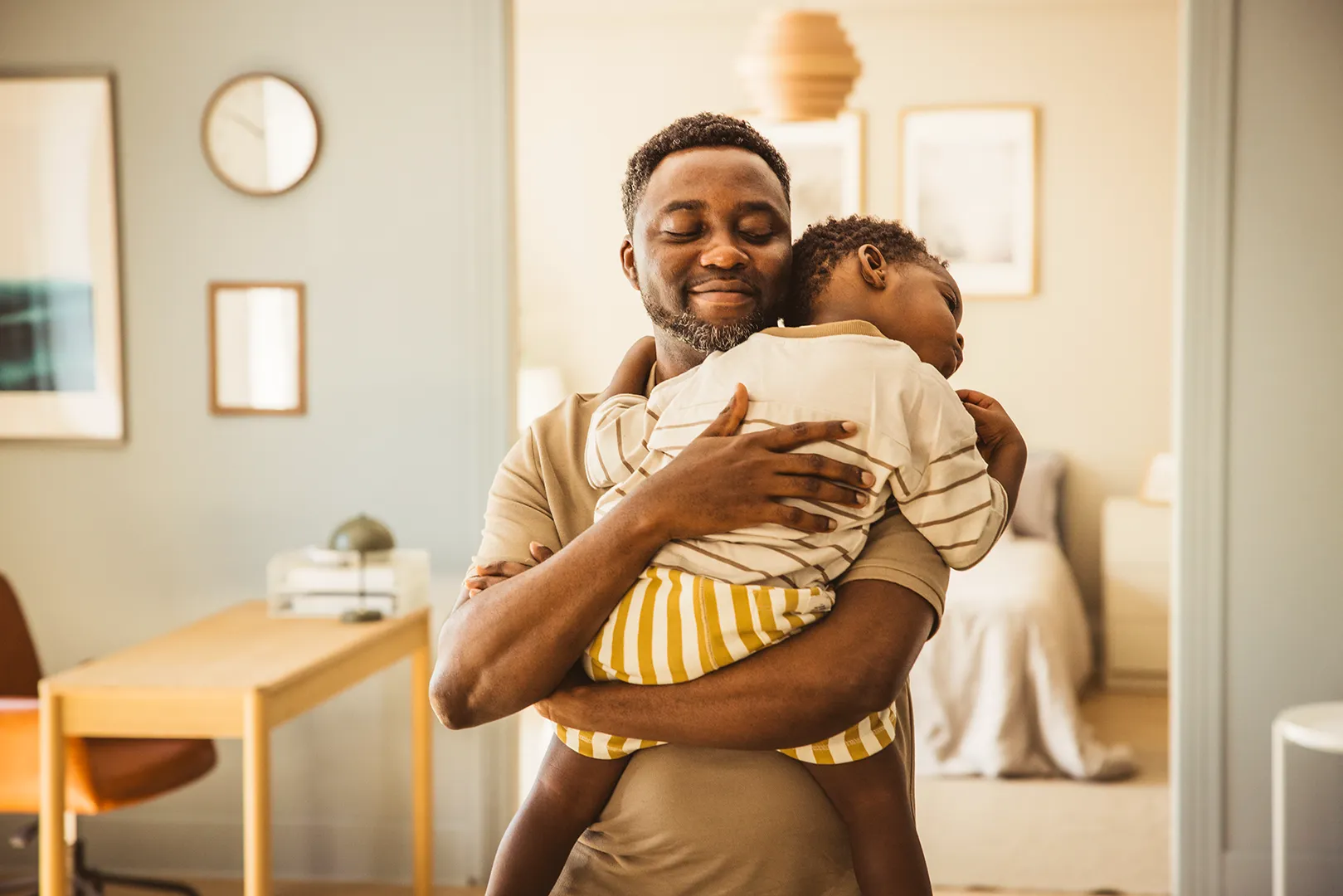 dad holding sleeping son
