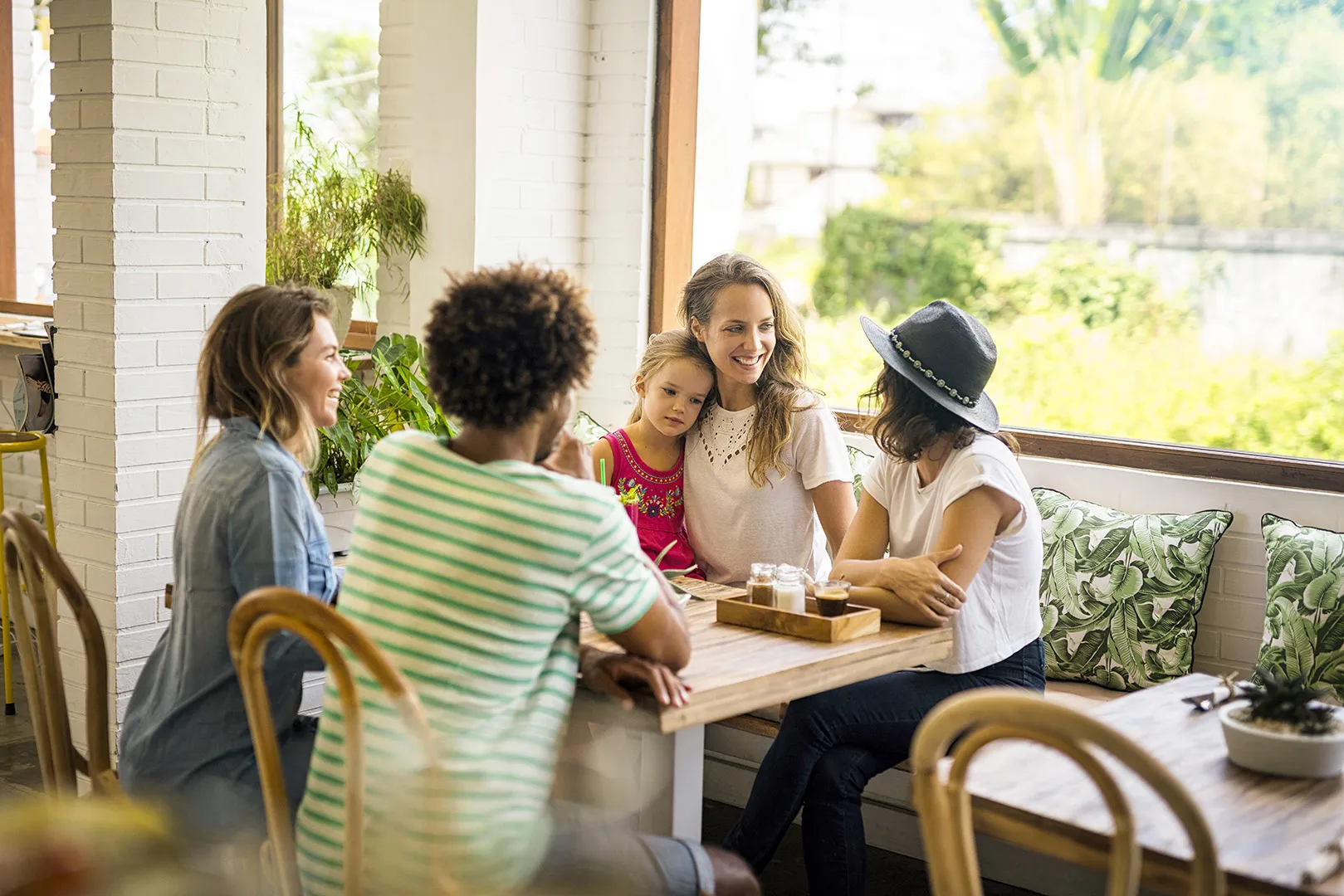 friends and child at a cafe