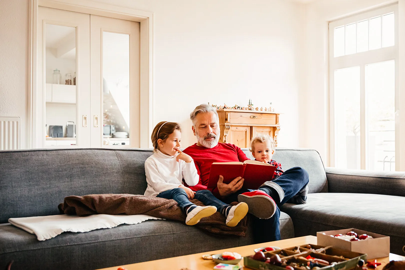 grandfather reading to grandkids
