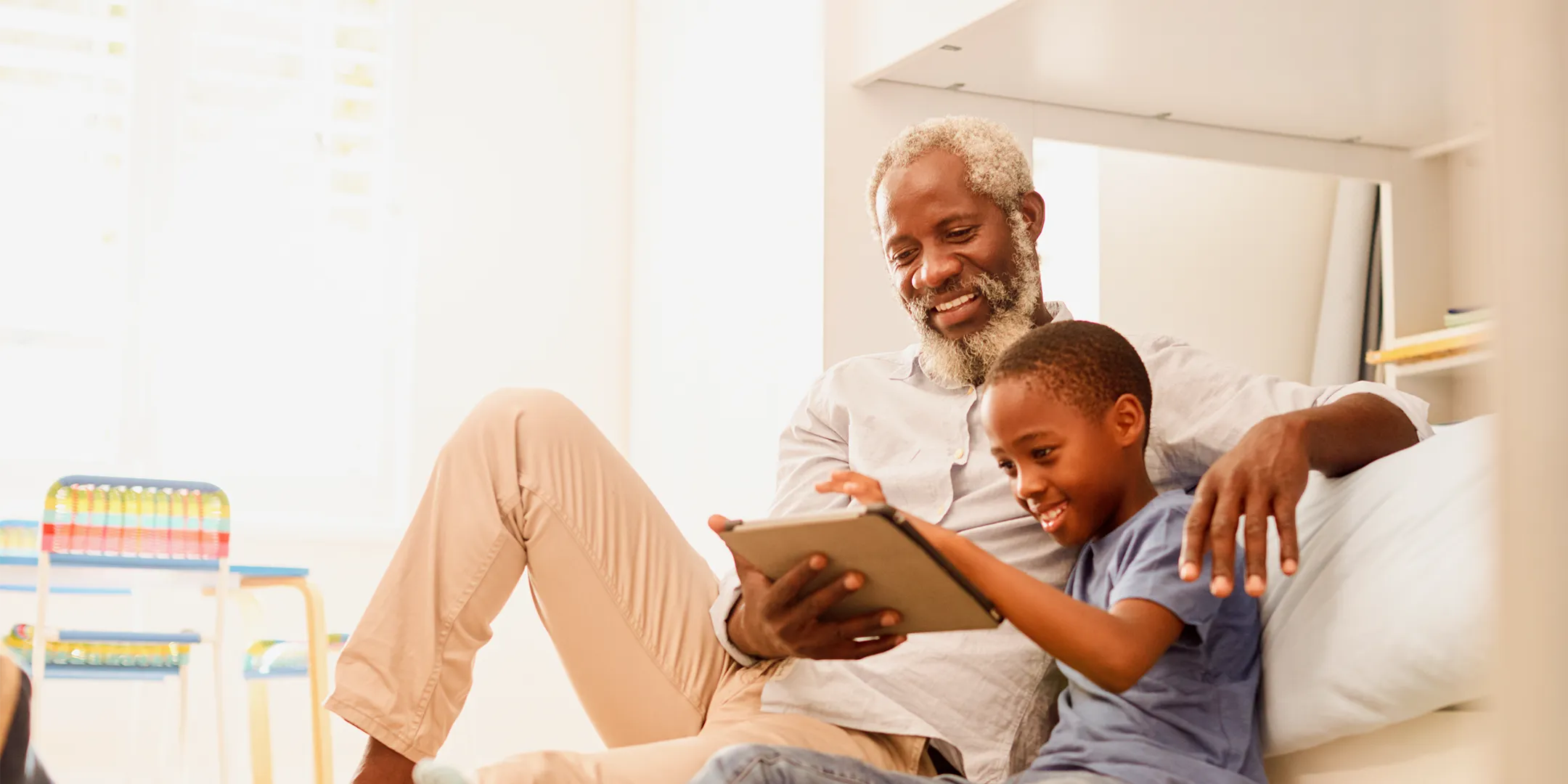 grandfather and grandson on ipad