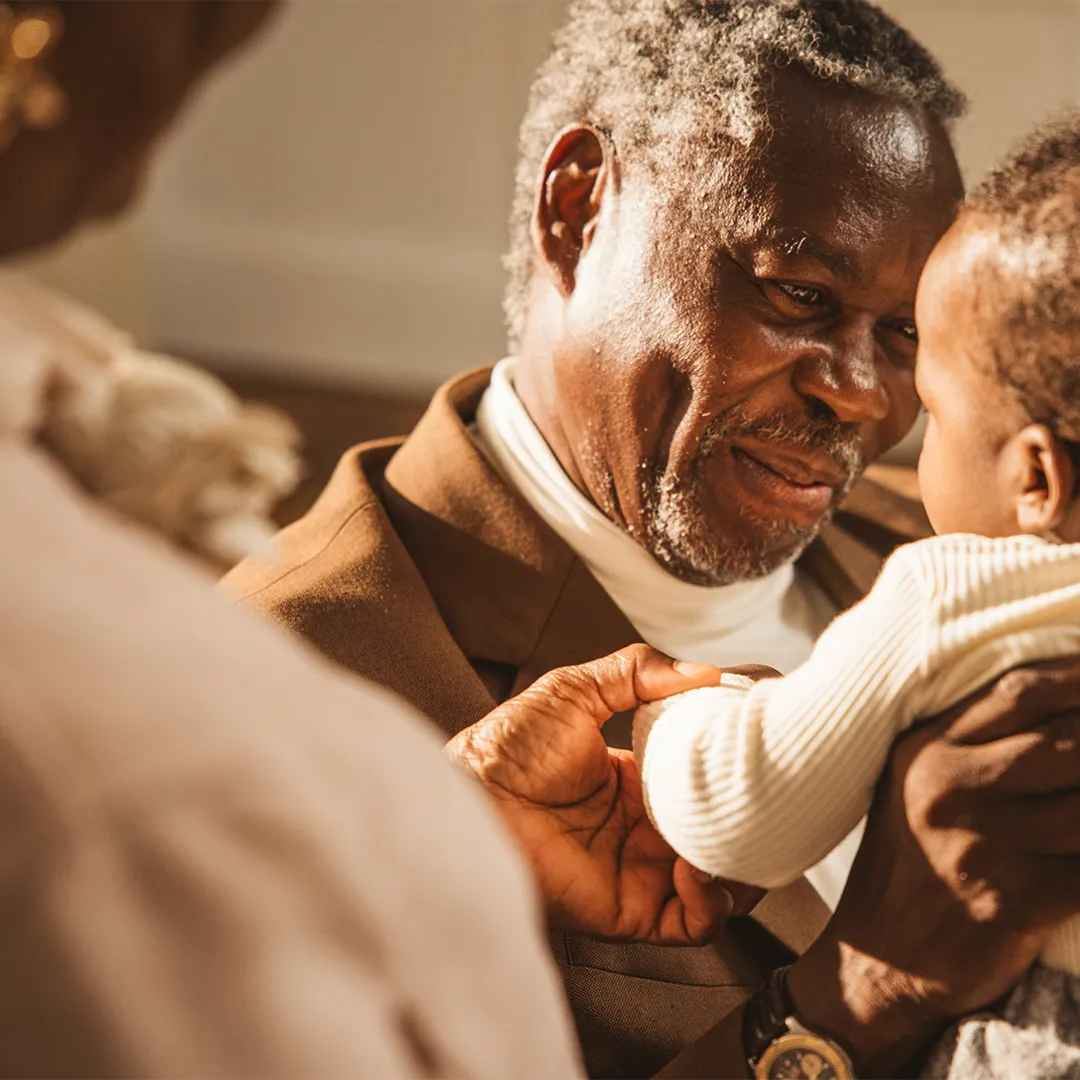 grandfather holding grandson