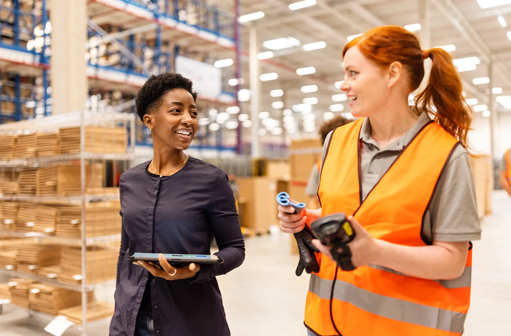 manager talking to worker in warehouse