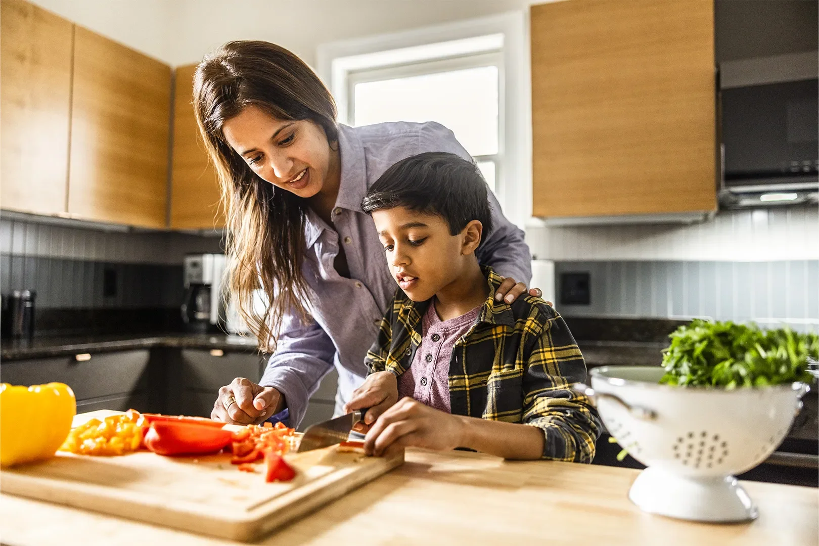 mom and son chopping vegetables