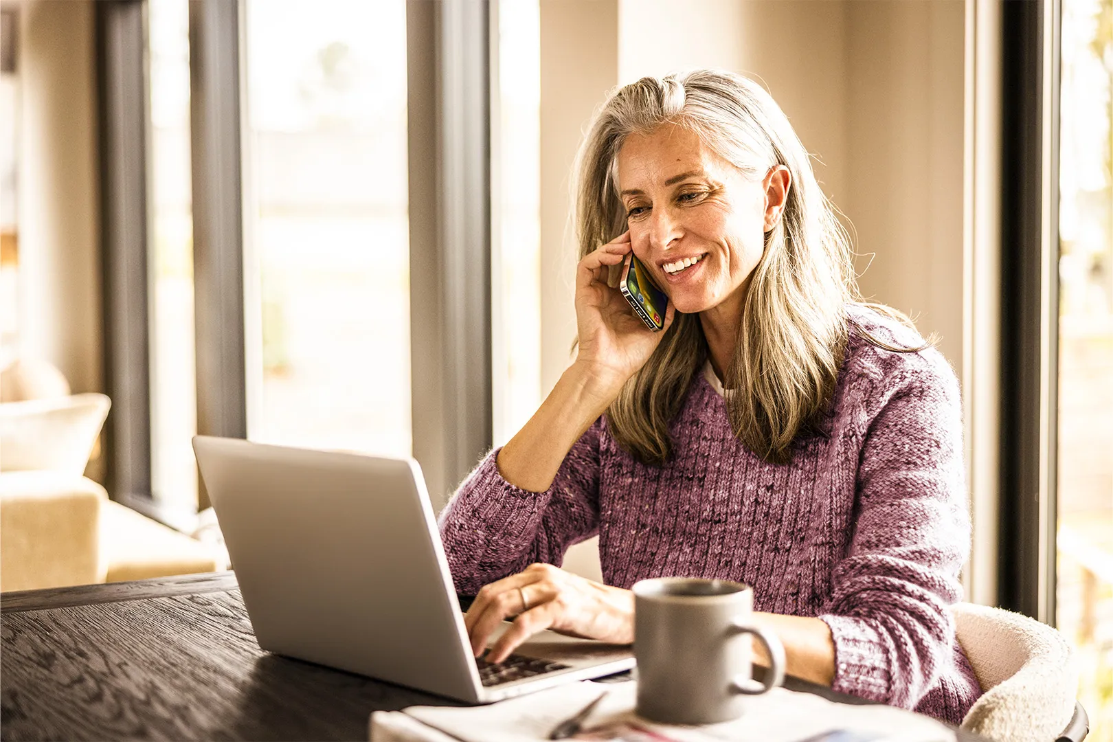 older woman on phone and laptop