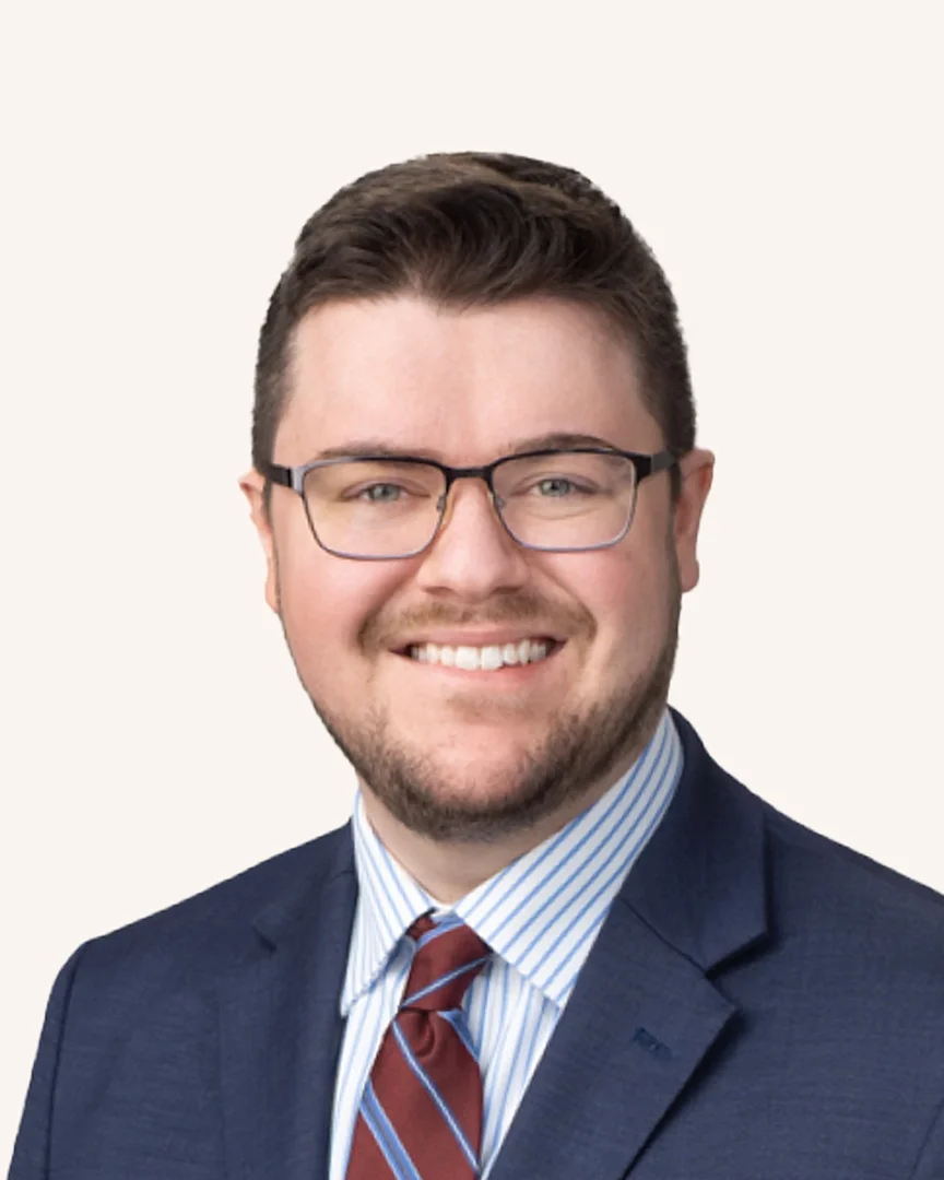 Headshot of a man smiling in a suit