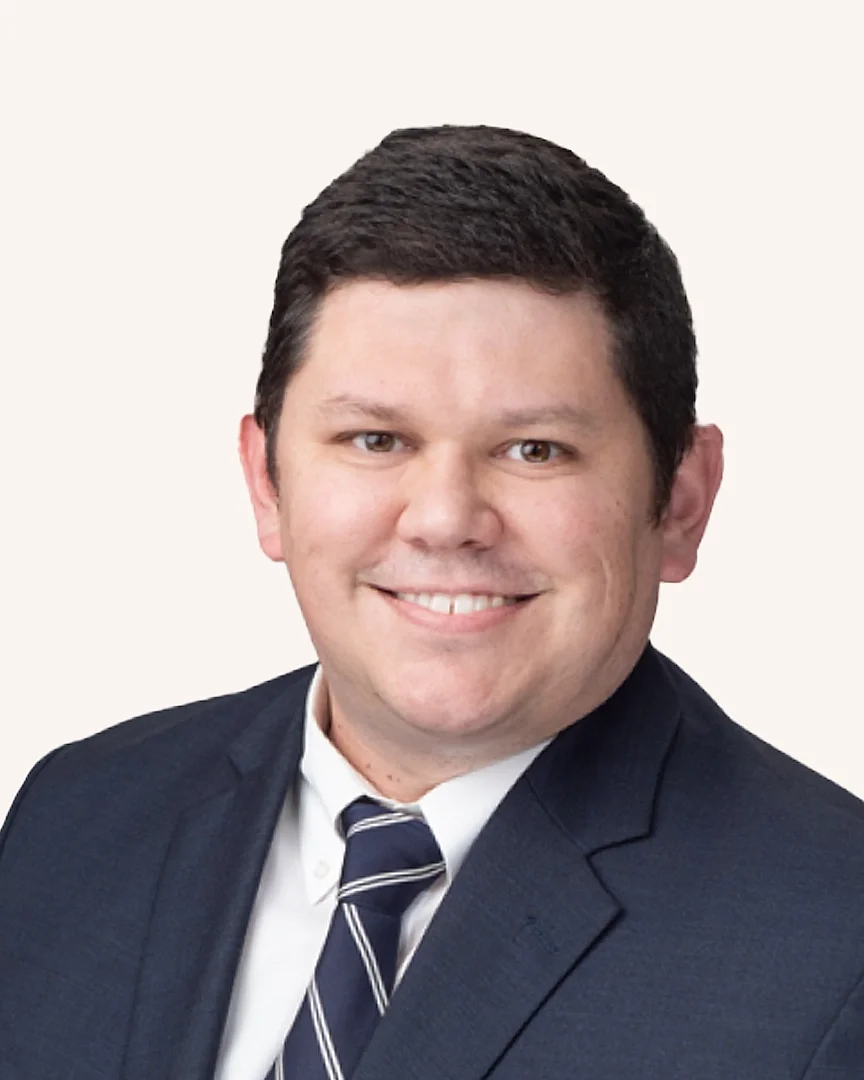 Headshot of a man smiling in a suit