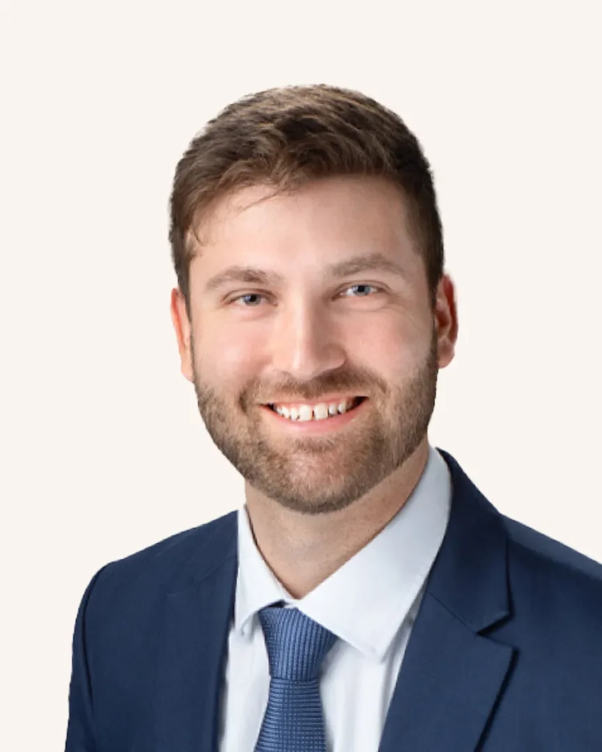 Headshot of a man smiling in a suit