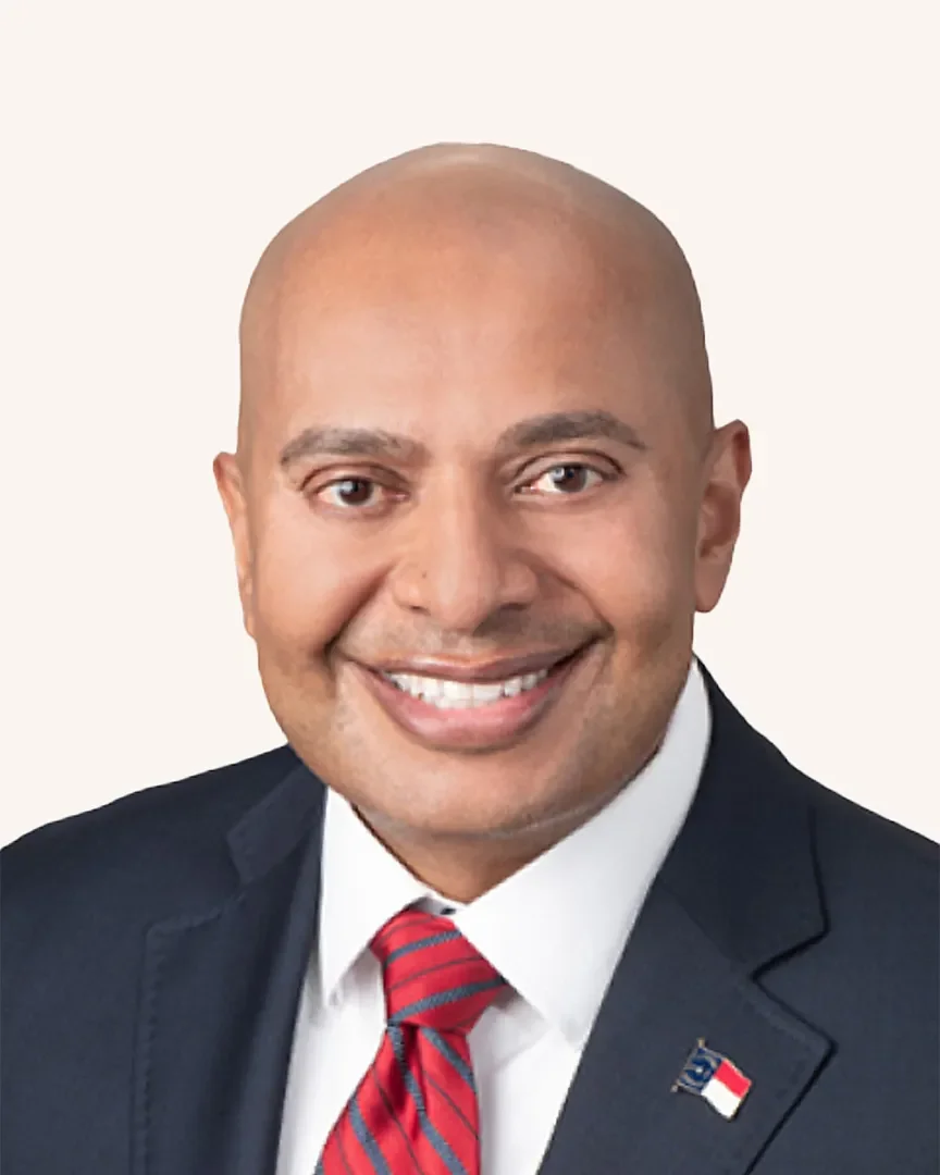 Headshot of a man smiling in a suit