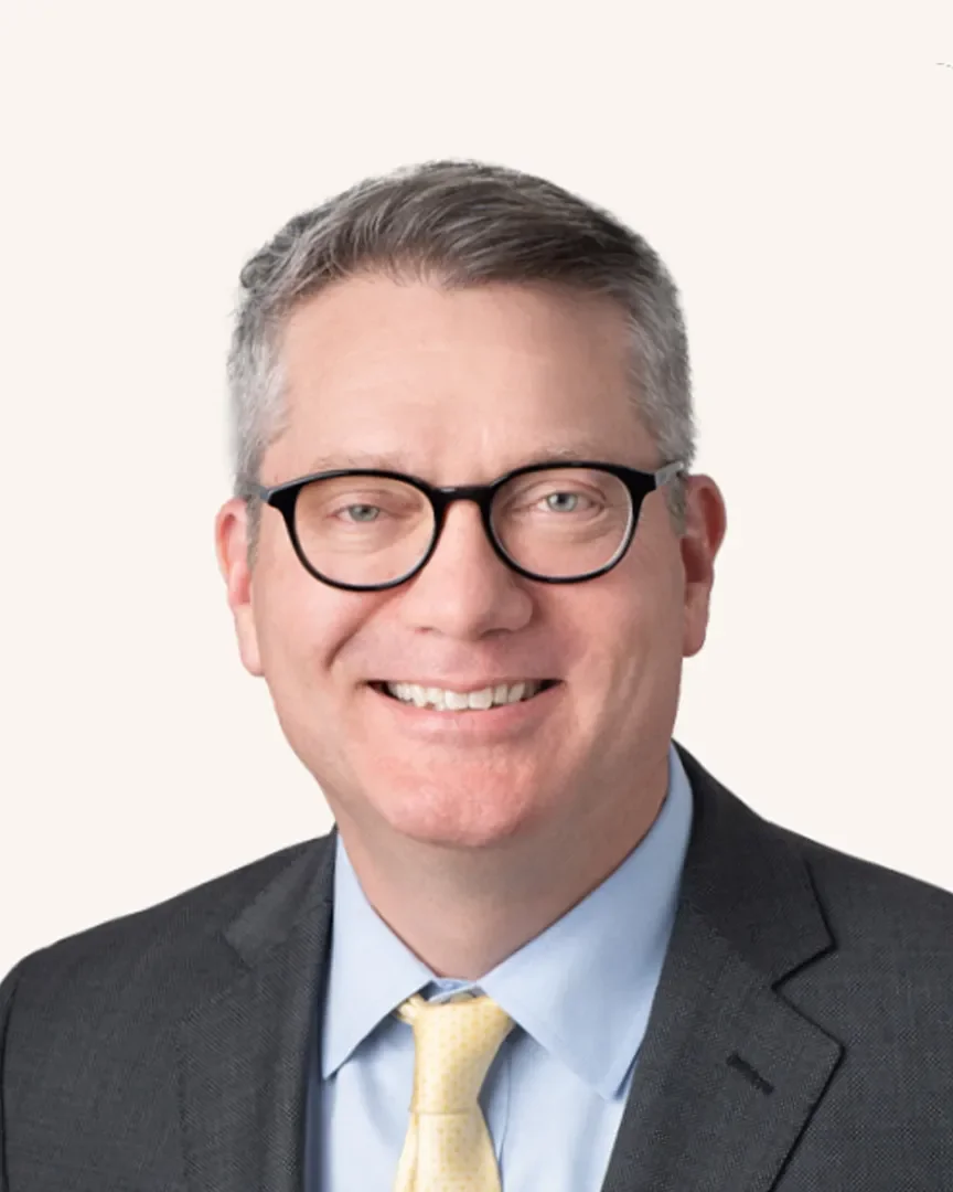 Headshot of a man smiling in a suit