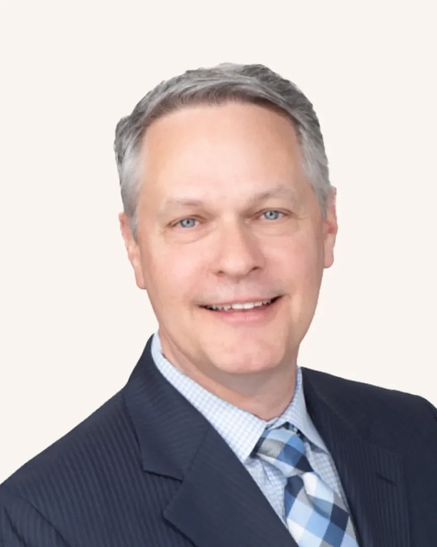 Headshot of a man smiling in a suit