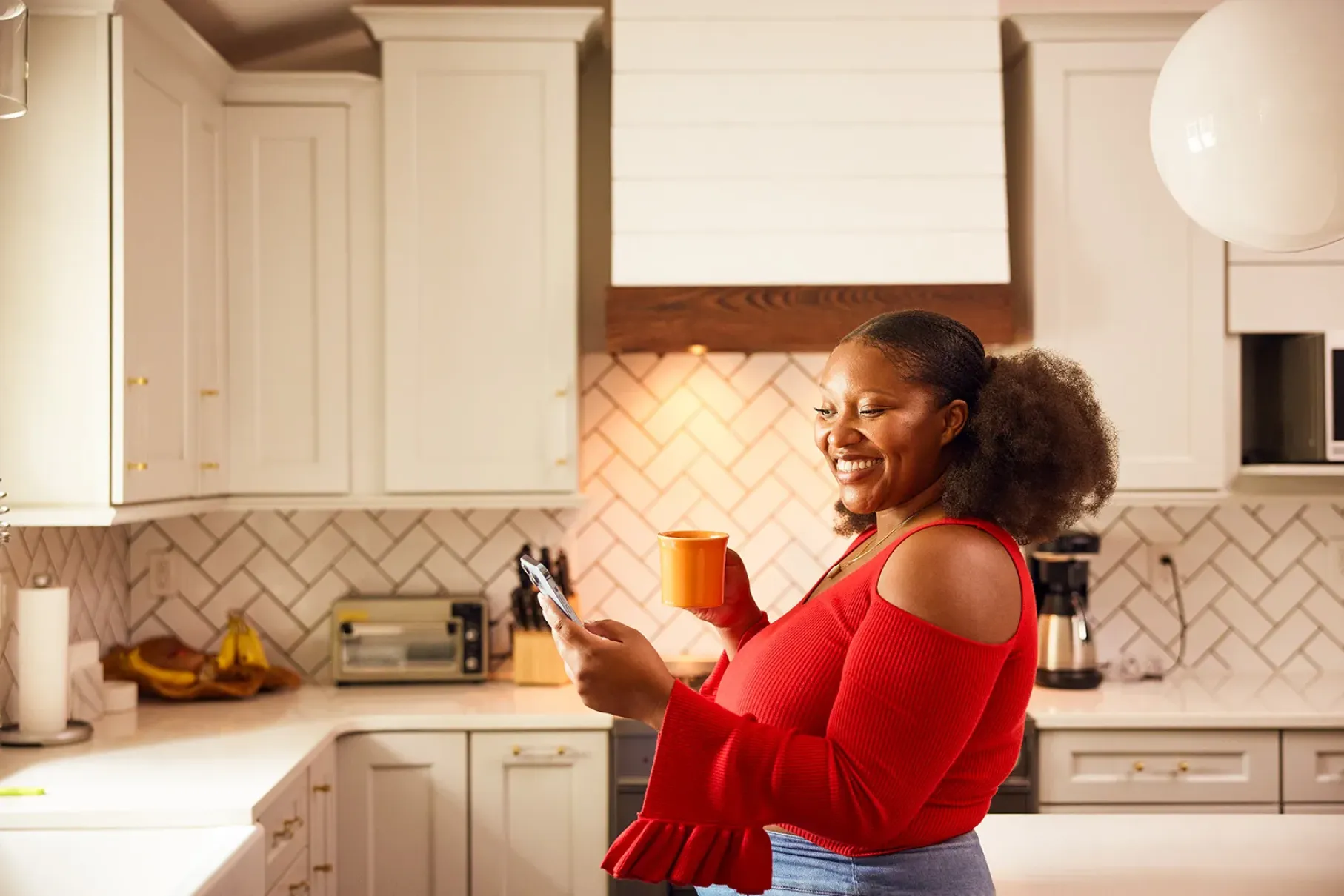 young woman on phone in the kitchen