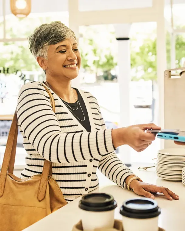 woman paying at cafe register