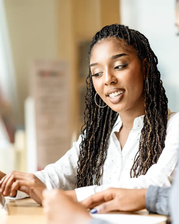 two women looking at a tablet together