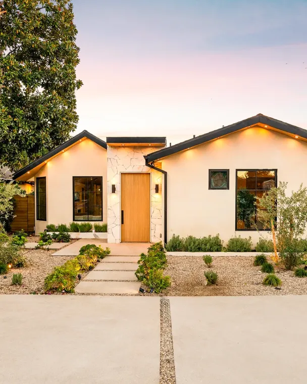 front of modern home with cozy warm lighting