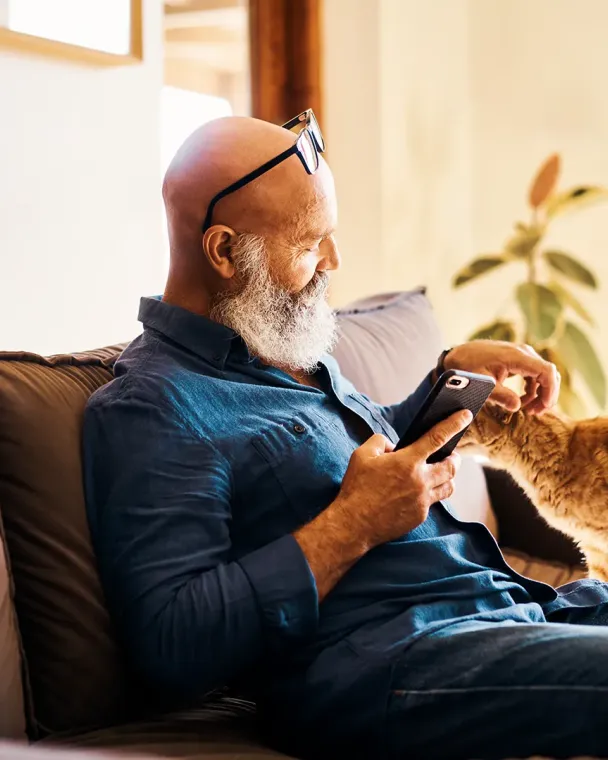 older man petting cat