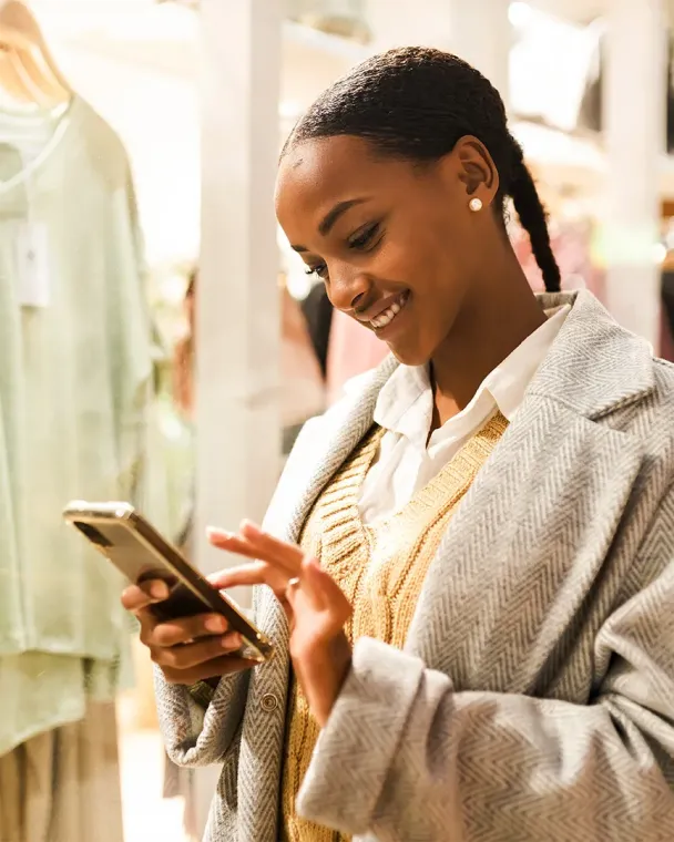teen on phone in clothing store