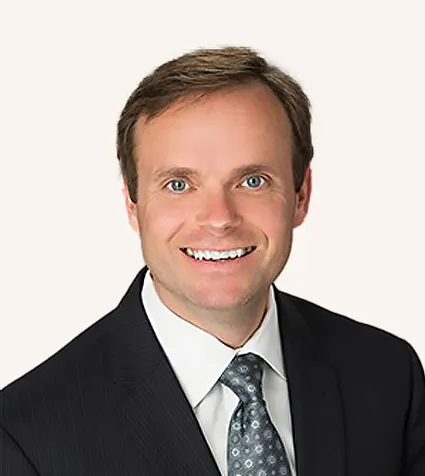 Headshot of a man smiling in a suit