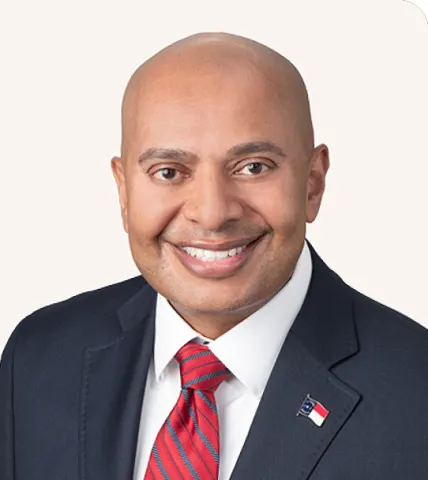Headshot of a man smiling in a suit