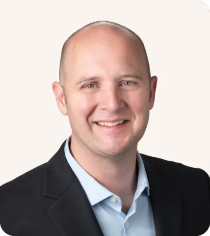 Headshot of a man smiling in a suit