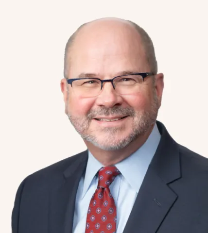Headshot of a man smiling in a suit