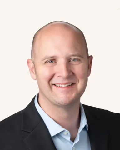 Headshot of a man smiling in a suit
